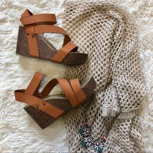 Tan strappy cork wedges.